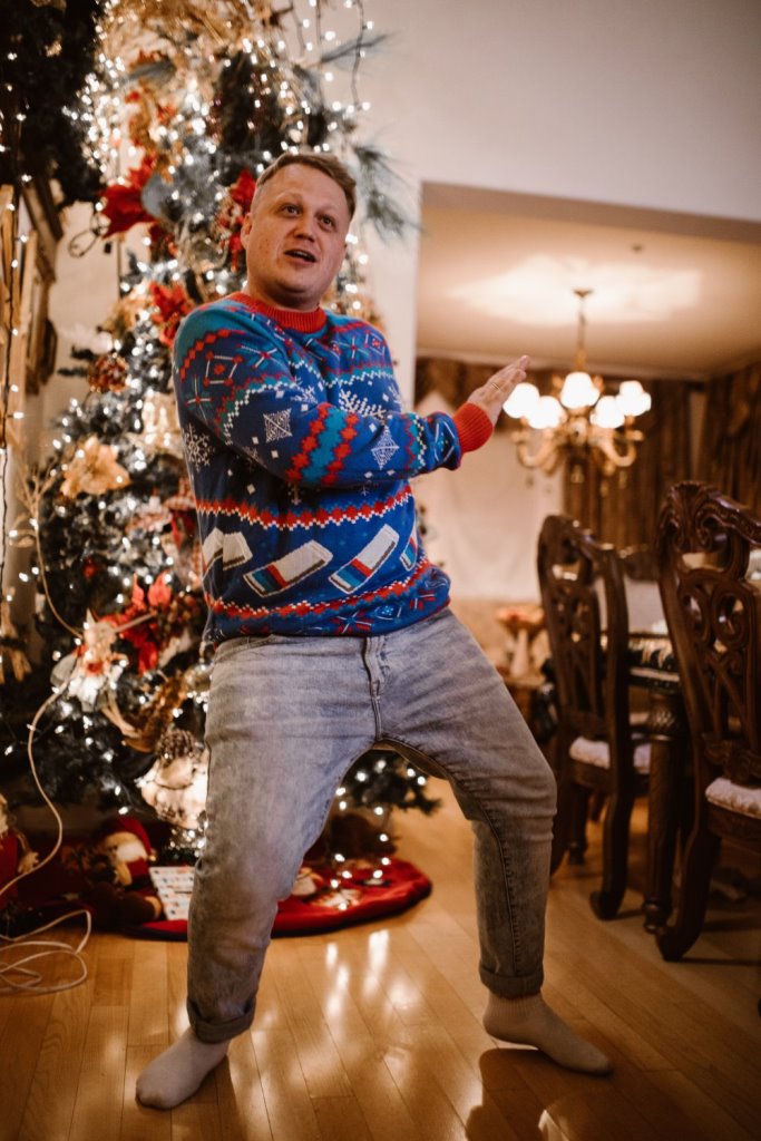 man dancing near the Christmas tree