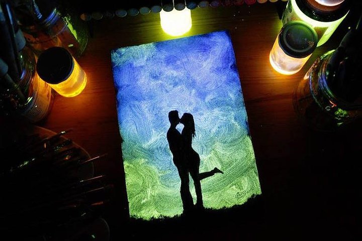 a painting of a couple glowing in the dark